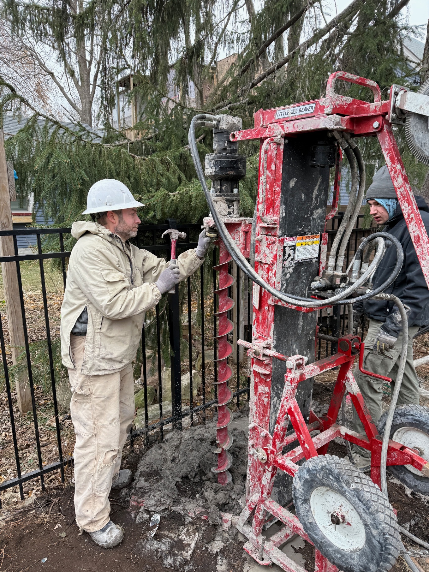 Compact geothermal drill rig operating in a narrow Chicago backyard