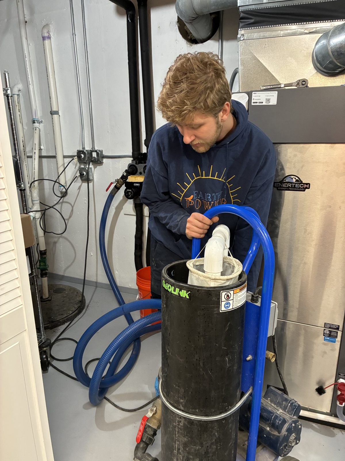 Earth Power technician servicing a residential geothermal system