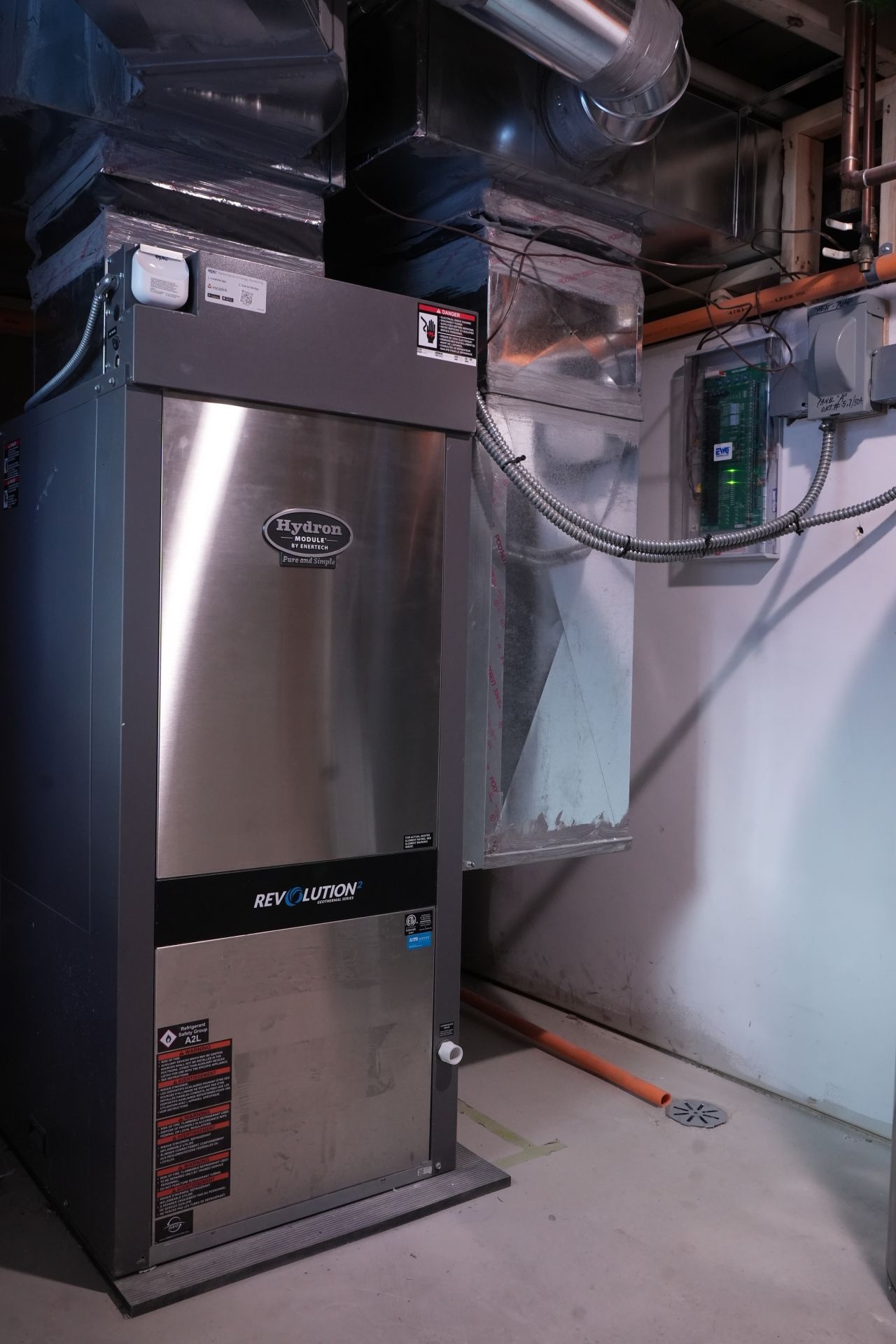 Professional geothermal heat pump installation in a residential basement